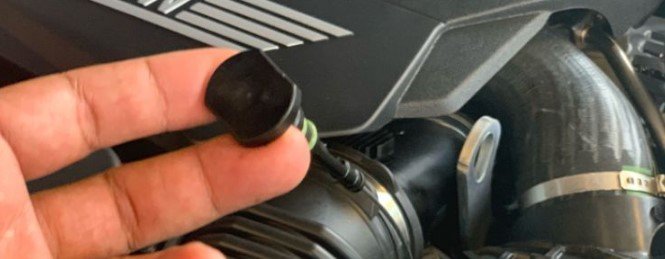 Where is the oil dipstick located on the 2011 BMW 328i